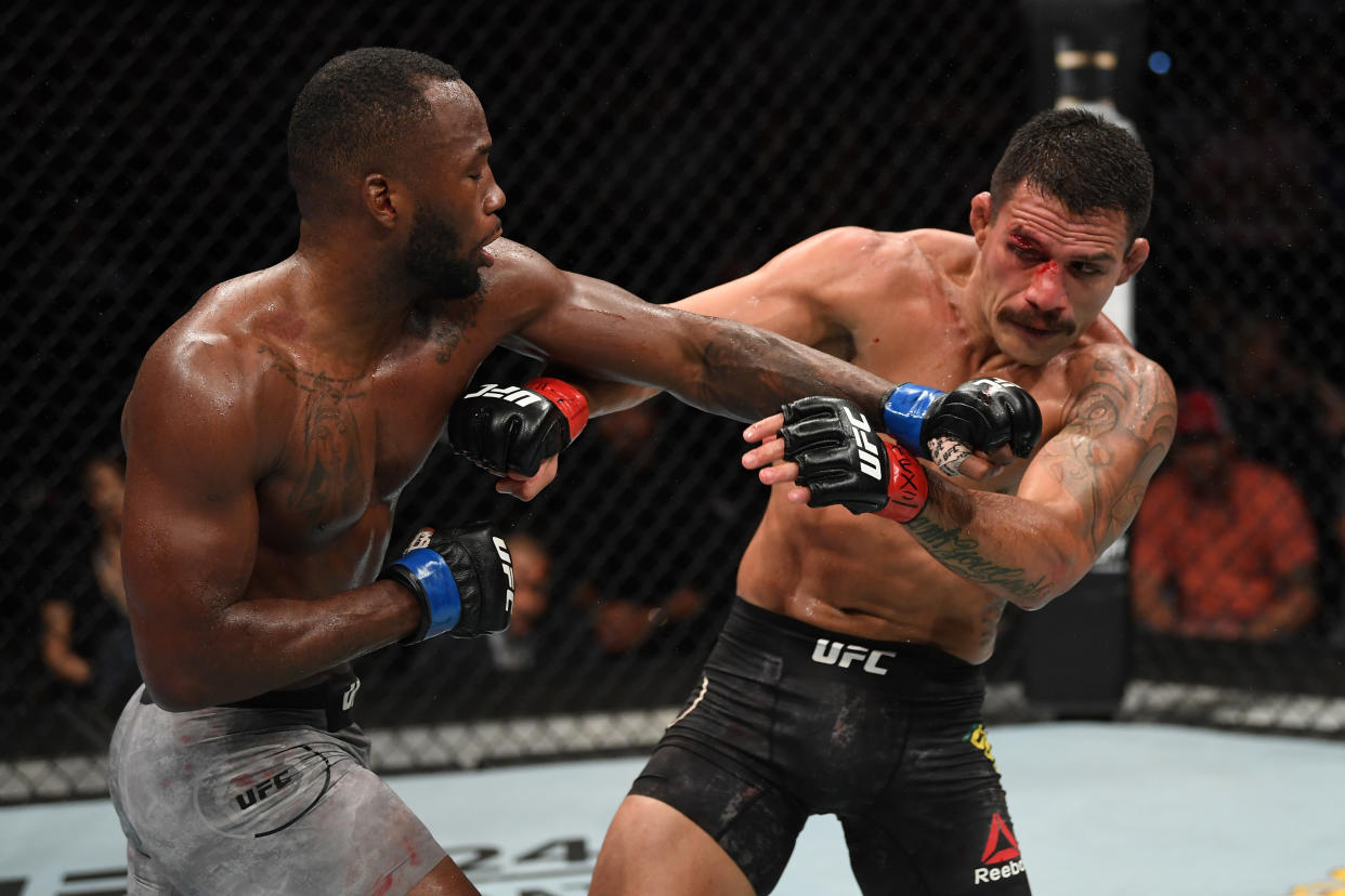 SAN ANTONIO, TEXAS - JULY 20:  (L-R) Leon Edwards of Jamaica punches Rafael Dos Anjos of Brazil in their welterweight bout during the UFC Fight Night event at AT&T Center on July 20, 2019 in San Antonio, Texas. (Photo by Josh Hedges/Zuffa LLC/Zuffa LLC via Getty Images)