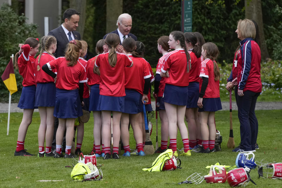 President Joe Biden and Ireland's Taoiseach Leo Varadkar talk with children after watching a youth Gaelic sports demonstration at Farmleigh House, Thursday, April 13, 2023, in Dublin, Ireland. (AP Photo/Patrick Semansky)
