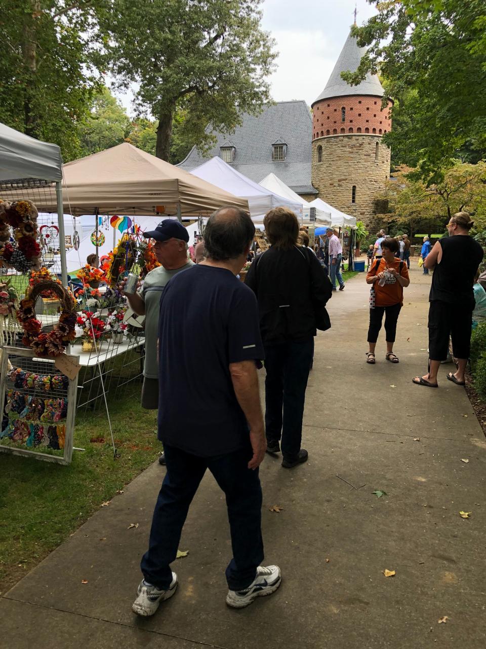 Patrons browse by booths in front of the museum at Audubon State Park during the 2021 Arts & Crafts Festival sponsored by the Henderson Lions Club.