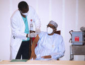 In this photo released by the Nigeria State House, Nigerian President Muhammadu Buhari, receives one of the country's first coronavirus vaccinations using AstraZeneca COVID-19 vaccine manufactured by the Serum Institute of India and provided through the global COVAX initiative, in Abuja Nigeria Saturday, March 6, 2021. Urgent calls for COVID-19 vaccine fairness rang through African countries on Friday, rolling out doses from the global COVAX initiative, with officials acutely aware their continent needs much more. (Sunday Aghaeze/Nigeria State House via AP)