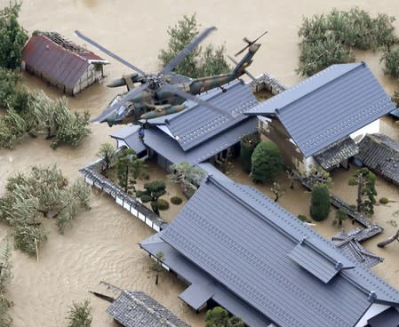 An aerial view shows a local rewsident is rescued by a Japan Self-Defence Force helicopter from residential areas flooded by the Chikuma river, caused by Typhoon Hagibis in Nagano, Japan
