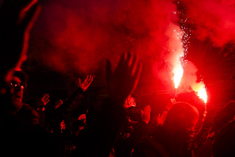 Members of the Emerald City Supporters light flares as they march to Lumen Field before an MLS playoff soccer match between the Seattle Sounders and FC Dallas, Monday, Oct. 30, 2023, in Seattle. (AP Photo/Lindsey Wasson)