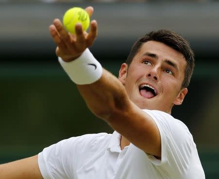 Bernard Tomic of Australia serves during his match against Novak Djokovic of Serbia at the Wimbledon Tennis Championships in London, July 3, 2015. REUTERS/Suzanne Plunkett