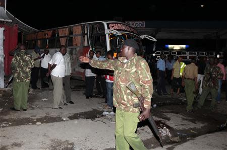 Armed police controls the crowd at the scene of an explosion at the populous Mwembe Tayari market, in the Kenyan coastal town of Mombasa May 3, 2014. REUTERS/Joseph Okanga