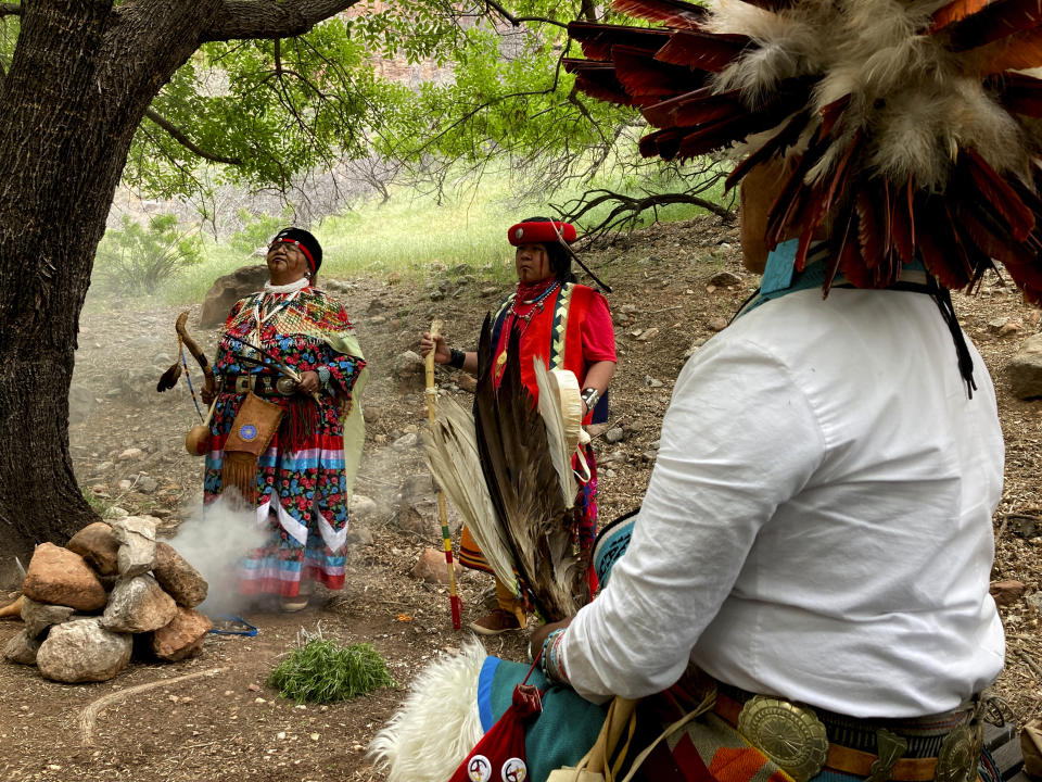Havasupai tribal members Dianna Sue Uqualla, left, Kris Siyuja and Uqualla bless a site of a popular campground at Grand Canyon National Park on Friday, May 5, 2023, that was renamed from Indian Garden to Havasupai Gardens. The site lies about 4.5 miles down the Bright Angel Trail in the canyon. (AP Photo/Felicia Fonseca)