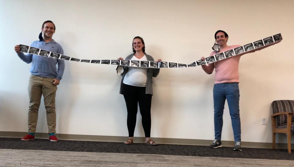 From left, Eric Portenga, Maureen Farris and Kevin O'Neill hold ultrasound pictures after they found out they would be having identical triplets. Farris was the surrogate for the babies.