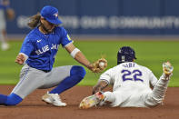 Tampa Bay Rays' Jose Siri (22) steals second base ahead of the tag by Toronto Blue Jays shortstop Bo Bichette during the sixth inning of a baseball game Friday, March 29, 2024, in St. Petersburg, Fla. (AP Photo/Chris O'Meara)