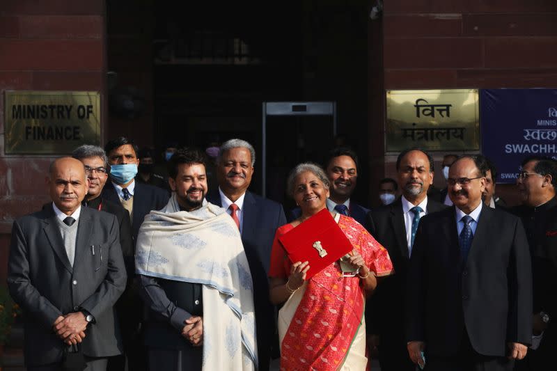 India's Finance Minister Nirmala Sitharaman holds up a folder with the Government of India logo, as she leaves her office to present the federal budget in the parliament in New Delhi