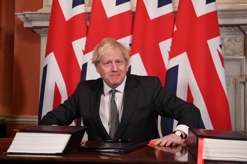 FILE PHOTO: Britain's Prime Minister Boris Johnson signs the Brexit trade deal with EU