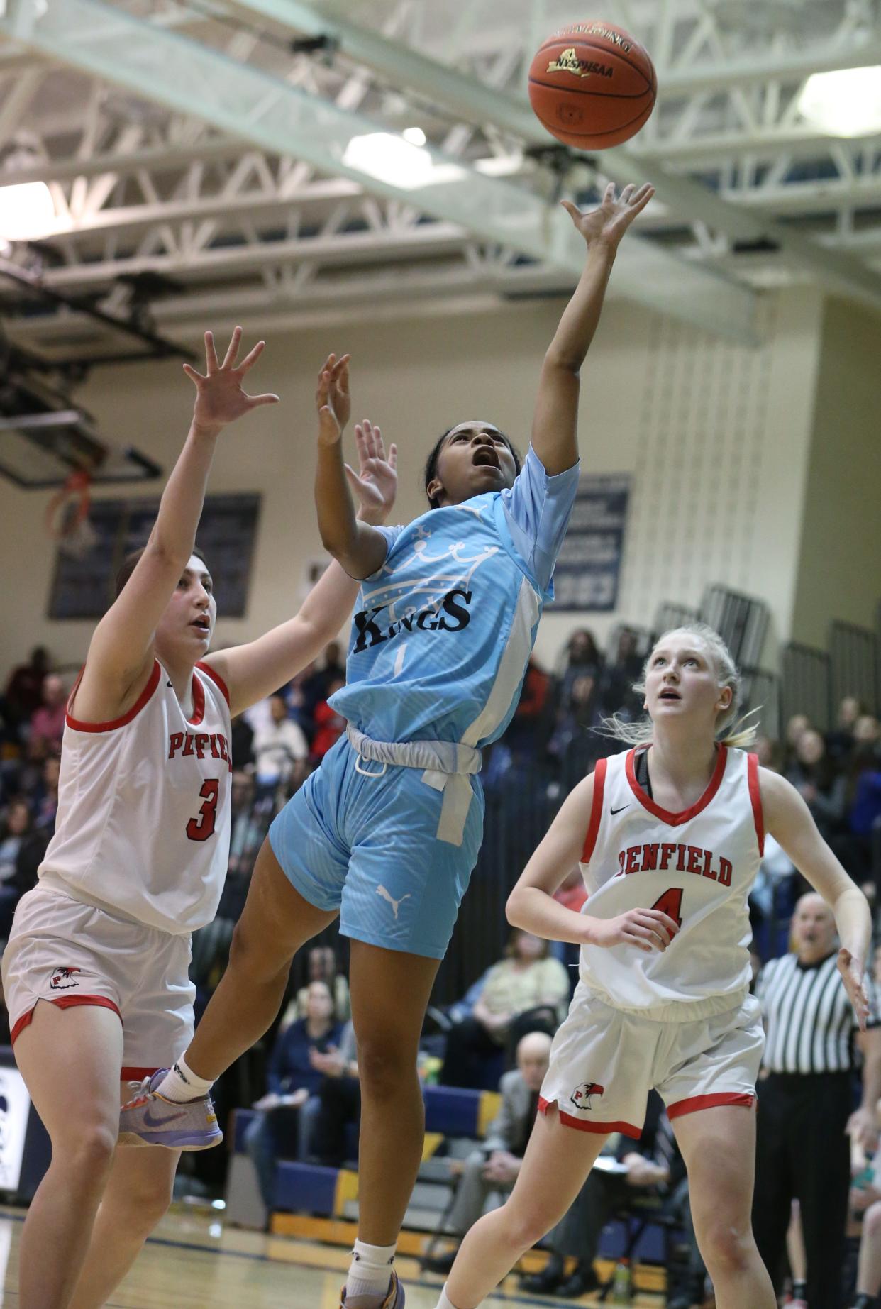 Kearney's Klarissa Goode drives in to score in the second quarter between Penfield's Lena Lipani and Ashley Kalvitis.