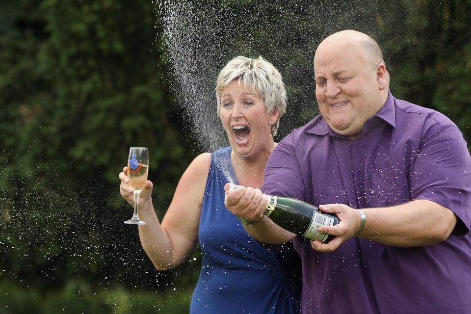 HATFIELD HEATH, ENGLAND - AUGUST 14: Adrian and Gillian Bayford celebrate winning the jackpot of over 148 million GBP in the EuroMillions lottery on August 14, 2012 in Hatfield Heath, England. The couple from Haverhill, Suffolk were the only winners of the Europe-wide lottery whose jackpot had rolled-over 14 times before being won by Mr and Mrs Bayford. (Photo by Oli Scarff/Getty Images)