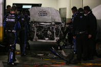 DAYTONA BEACH, FL - FEBRUARY 27: Crew members work on the #48 Lowe's Chevrolet driven by Jimmie Johnson in the garage after being involved in an on track incident during the NASCAR Sprint Cup Series Daytona 500 at Daytona International Speedway on February 27, 2012 in Daytona Beach, Florida. (Photo by Jerry Markland/Getty Images for NASCAR)