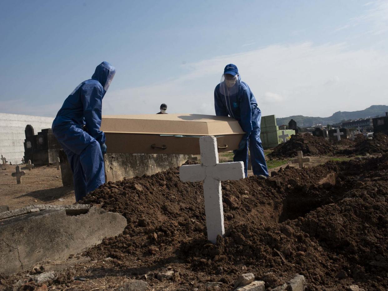 A victim of covid19 is buried in the cemetery of Inhauma, north of Rio de Janeiro: Anadolu Agency via Getty Images