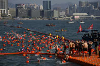 Competitors swim during a harbor race at the Victoria Harbor in Hong Kong, Sunday, Dec. 12, 2021. Hundreds of people took part in traditional swim across iconic Victoria Harbor after two years of suspension. (AP Photo/Kin Cheung)