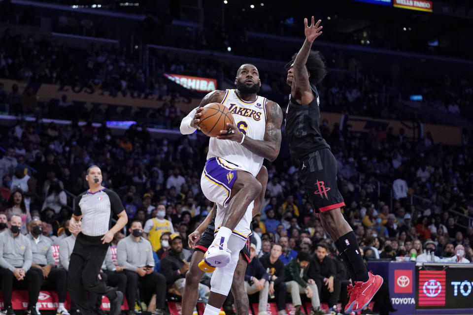Los Angeles Lakers forward LeBron James, left, shoots as Houston Rockets guard Kevin Porter Jr. defends during the first half of an NBA basketball game Sunday, Oct. 31, 2021, in Los Angeles. (AP Photo/Mark J. Terrill)