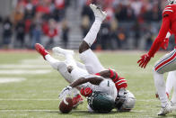 Ohio State defensive back Denzel Burke, right, tackles Michigan State receiver Jayden Reed during the first half of an NCAA college football game Saturday, Nov. 20, 2021, in Columbus, Ohio. (AP Photo/Jay LaPrete)