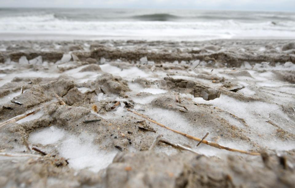 Snow and ice along an empty beach in Wrightsville Beach, N.C., Saturday January 22, 2022. A wintry mix fell throughout the night over the Wilmington area and created dangerous conditions.    [MATT BORN/STARNEWS]