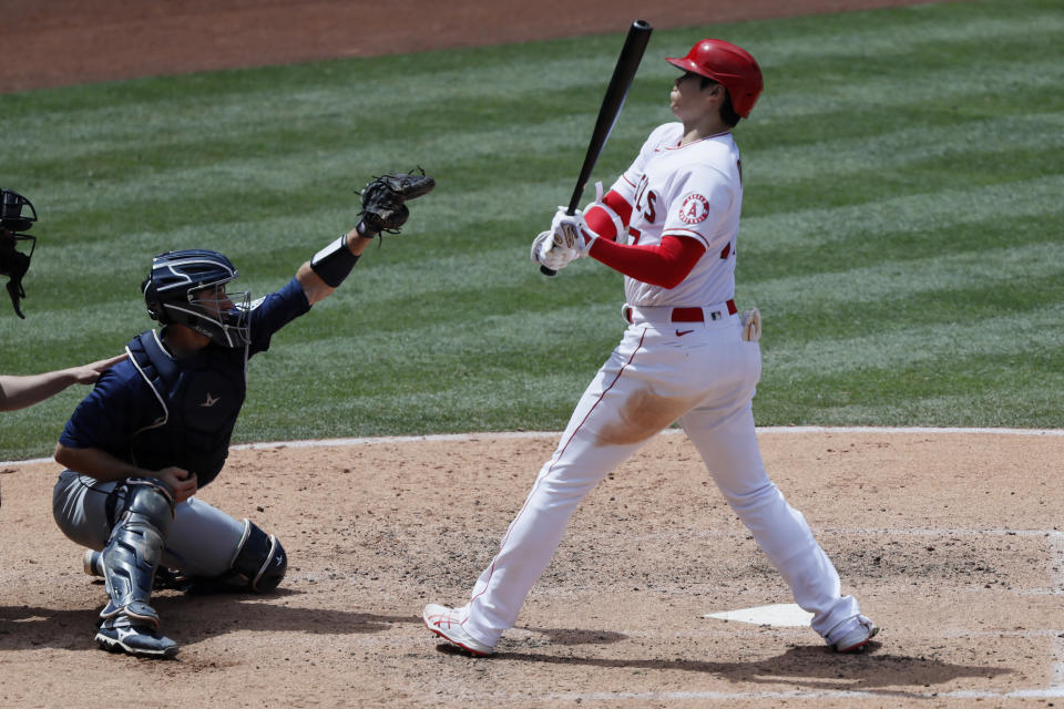 Los Angeles Angels designated hitter Shohei Ohtani, right, gets out of the way of an inside pitch caught by Seattle Mariners catcher Tom Murphy, left, during the fourth inning of a baseball game in Anaheim, Calif., Sunday, June 6, 2021. (AP Photo/Alex Gallardo)