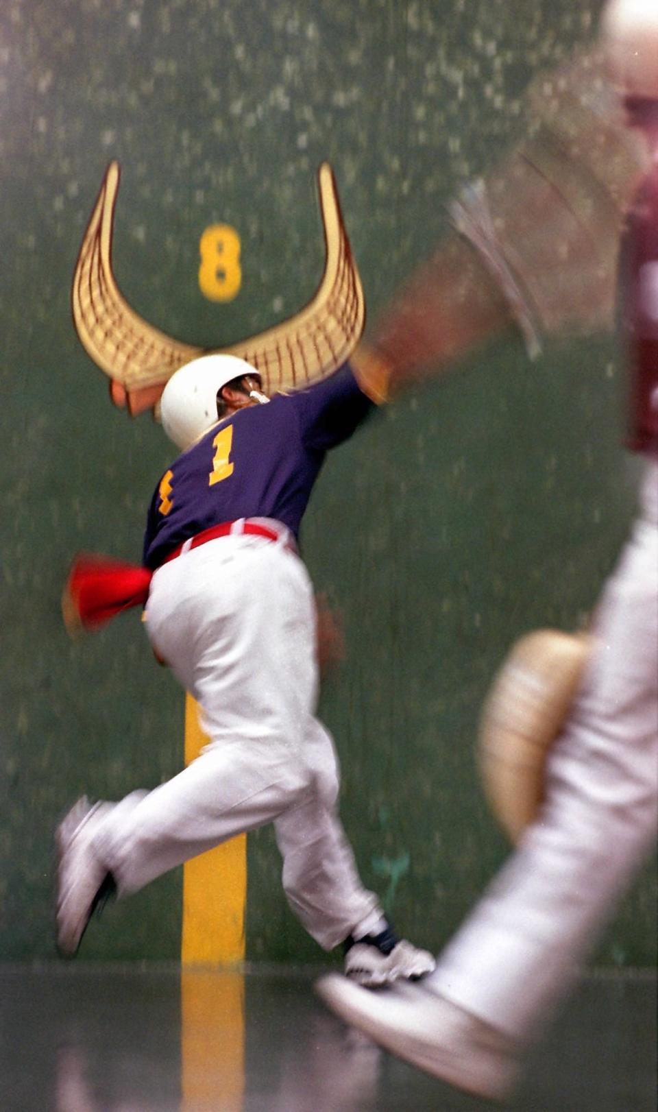 Blue number 11 Enrique makes a forehand returned during the doubles fourth game of the day, Wednesday April 7, 1999 at the Fort Pierce Jai Alai.