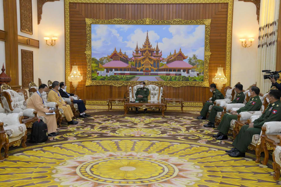 In this photo provided by the Myanmar Military True News Information Team, Senior Gen. Min Aung Hlaing, center, head of the military council, talks with Yawd Serk, third from left, chairman of the Restoration Council of Shan State/Shan State Army, during their meeting Friday, May 20, 2022, in Naypyitaw, Myanmar. (Military True News Information Team via AP)