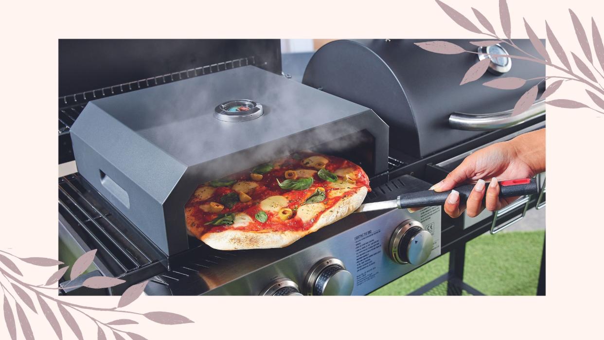  Aldi pizza oven lifestyle image of woman using pizza oven in garden. 