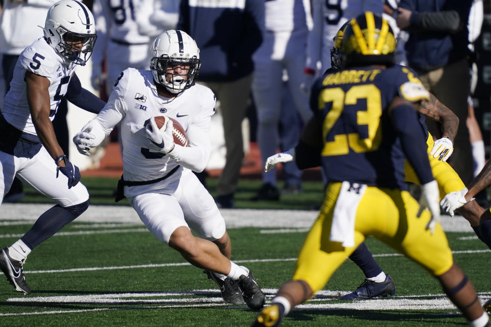 Penn State wide receiver Parker Washington (3) looks for running room as Michigan linebacker Michael Barrett (23) closes in during the first half of an NCAA college football game, Saturday, Nov. 28, 2020, in Ann Arbor, Mich. (AP Photo/Carlos Osorio)