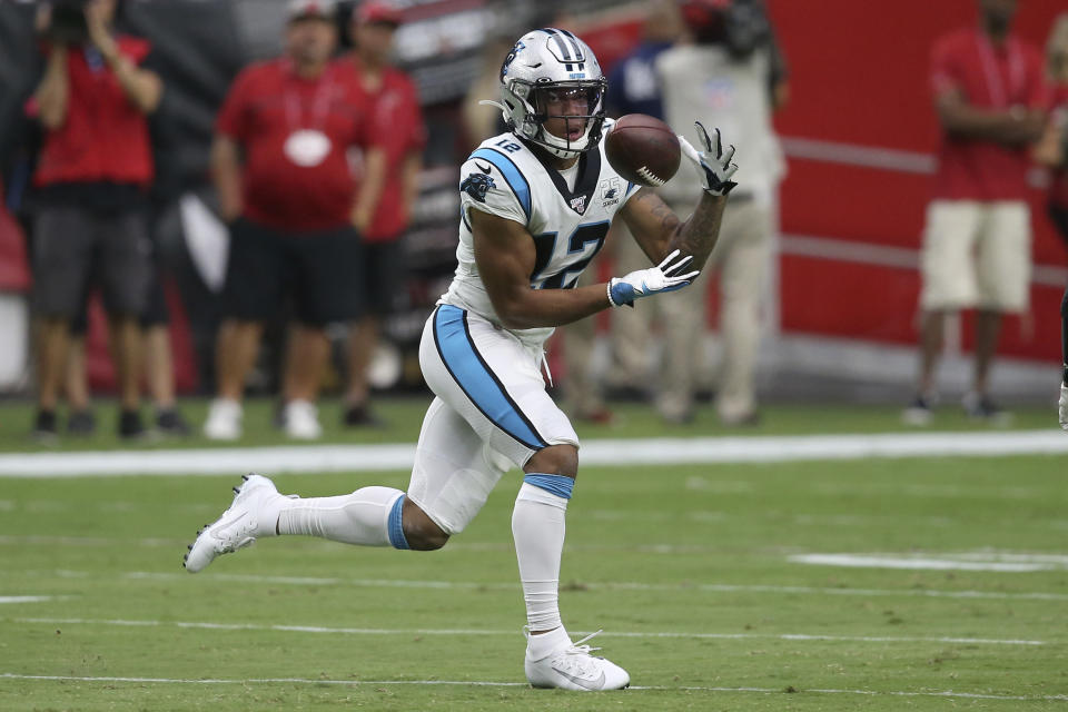 FILE - FILE - In this Sept. 22, 2019, file photo, Carolina Panthers wide receiver D.J. Moore (12) pulls in a touchdown catch against the Arizona Cardinals during the first half of an NFL football game in Glendale, Ariz. The Panthers have traded up to acquire the No. 1 overall pick in the draft from the Chicago Bears in exchange for Carolina's No. 9 and No. 61 overall picks in 2023, a first-round pick in 2024, a second-round pick in 2025 and star wide receiver D.J. Moore, two people familiar with the deal said Friday, March 10, 2023, The people spoke to The Associated Press on condition of anonymity because the trade had not been announced. (AP Photo/Ross D. Franklin, File)