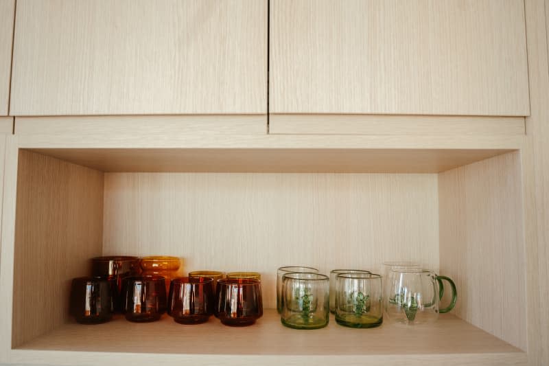 Glassware stored in kitchen shelf.