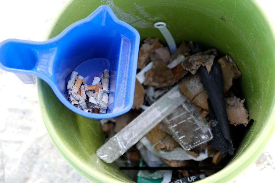 A volunteers bucket of trash and cigarette butts as they pick up trash following the holiday weekend on Tybee Island near the Pier and Pavilion.