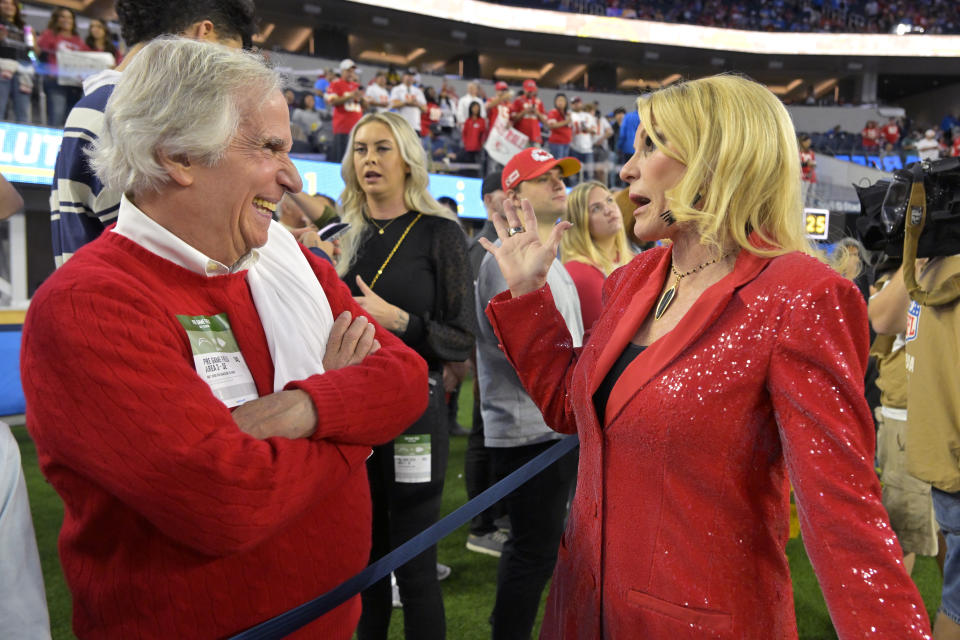 Actor Henry Winkler talks with Tammy Reid, wife of Kansas City Chiefs head coach Andy Reid, prior to an NFL football game between the Chiefs and the Los Angeles Chargers Sunday, Nov. 20, 2022, in Inglewood, Calif. (AP Photo/Jayne Kamin-Oncea)