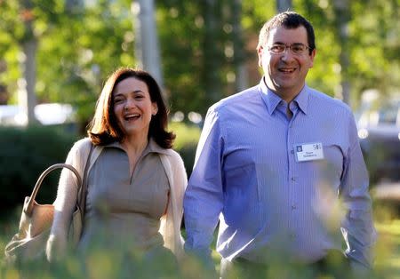 In this file photo, Sheryl Sandberg, Chief Operating Officer (COO) of Facebook, arrives with her husband David Goldberg, CEO of SurveyMonkey, for the first day of the Allen and Co. media conference in Sun Valley, Idaho July 9, 2014. REUTERS/Rick Wilking