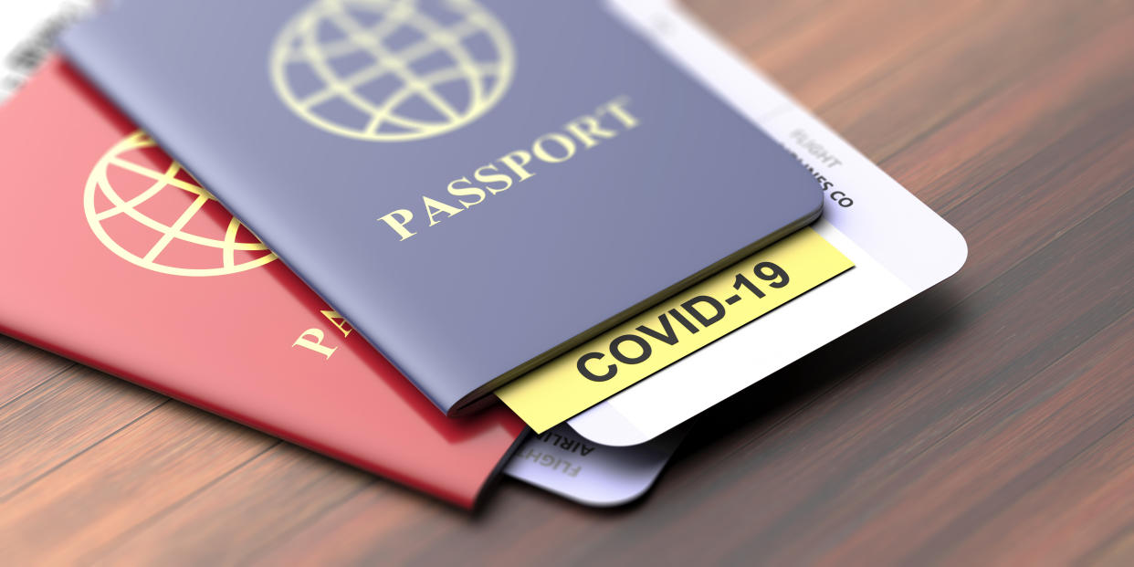 Coronavirus and travel concept. COVID-19 note on a passport. Border control and tourists infected quarantine,
Travelling documents on wooden table, closeup view. 3d illustration