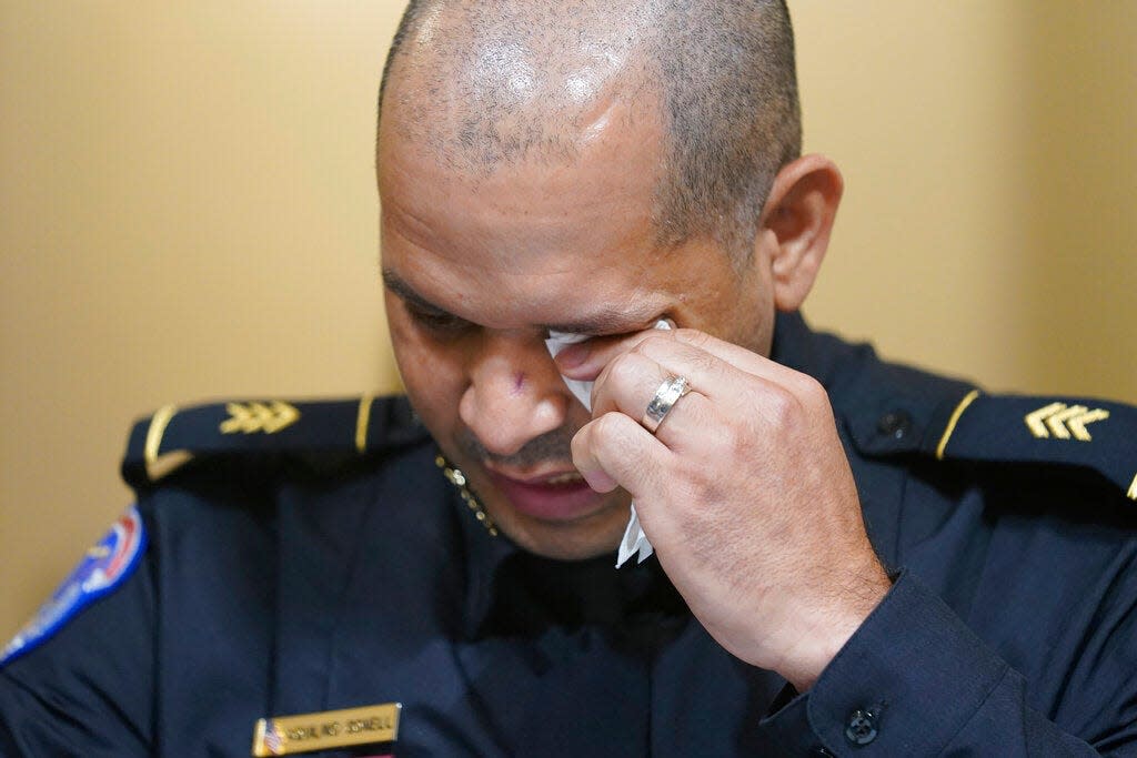 U.S. Capitol Police Sgt. Aquilino Gonell wipes his eyes as he testifies during the House select committee hearing on the Jan. 6 attack on Capitol Hill in Washington, on July 27, 2021.