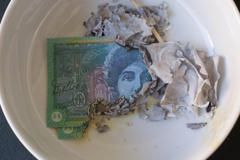 Pictured: Burnt Australian banknote. Image: Getty