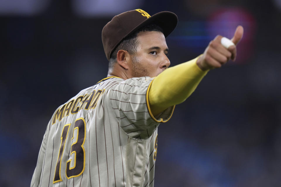 San Diego Padres third baseman Manny Machado gestures after throwing a ball to a fan in the crowd before the ninth inning of the team's baseball game against the Toronto Blue Jays on Tuesday, July 18, 2023, in Toronto. (Chris Young/The Canadian Press via AP)