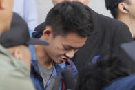 Chan Tong-kai bows after talking to the media as he is released from prison in Hong Kong Wednesday, Oct. 23, 2019. Chan, who's wanted for killing his girlfriend last year on the self-ruled island, had asked the Hong Kong government for help turning himself in to Taiwan after his sentence for money laundering offenses ends on Wednesday. (AP Photo/Kin Cheung)