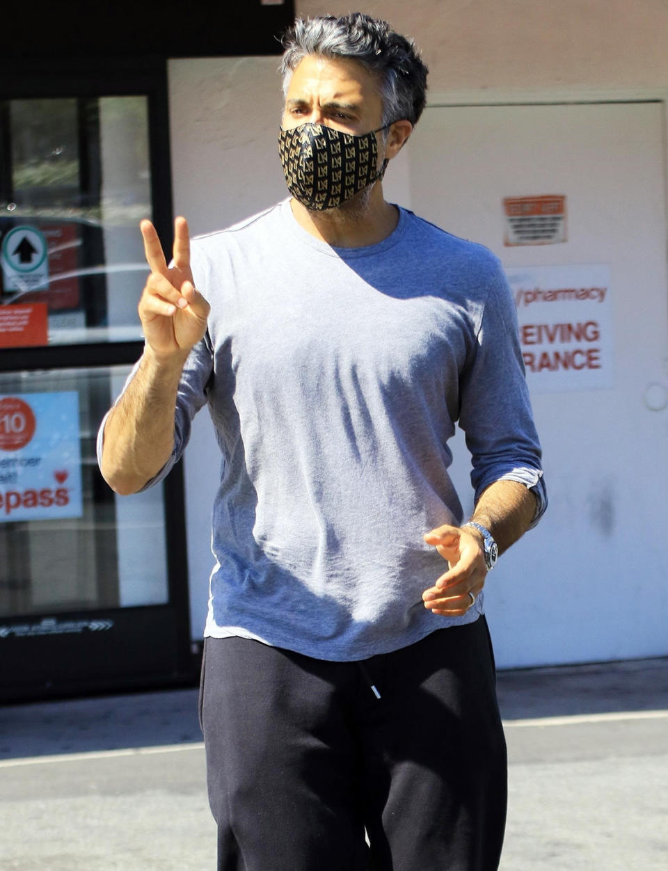 <p>Jaime Camil holds up a peace sign as he leaves a CVS in L.A. on Wednesday.</p>