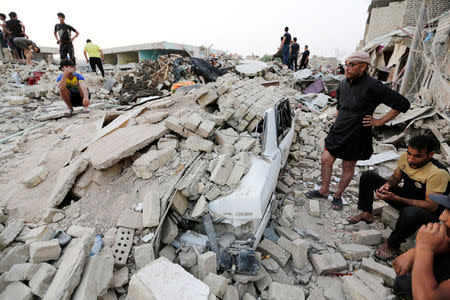 People gather at the site of an explosion in Baghdad's Sadr City district, Iraq, June 7, 2018. REUTERS/Wissm al-Okili