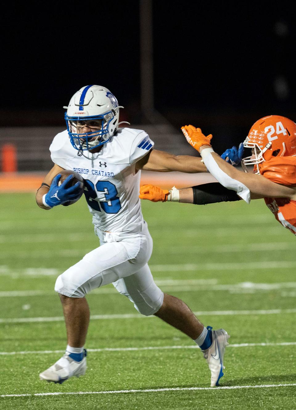 Bishop Chatard Trojan Jack Weybright (23) stiff-arms Hamilton Heights Huskies Chance Yeager (24) on Friday, Oct. 29, 2022, at Hamilton Heights High School in Arcadia. 