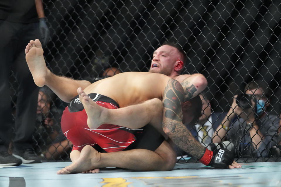 Conor McGregor battles Dustin Poirier (top) in their lightweight bout during UFC 264 on July 10. (Louis Grasse/PxImages/Icon Sportswire via Getty Images)