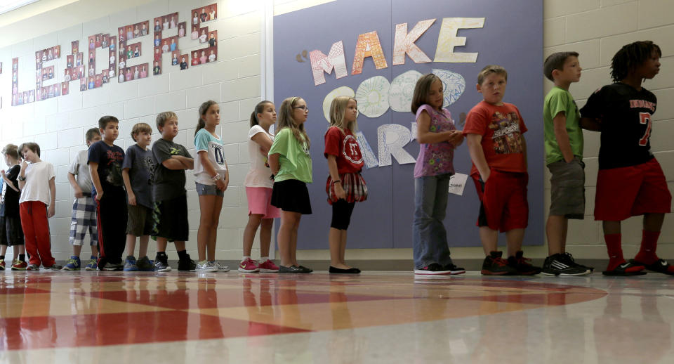 In this photo taken Friday, Sept. 6, 2013, students wait to go to art class at Indian Trails Elementary school in Independence, Mo. The school is one of 1,400 nationwide utilizing a program called "The Leader in Me" which is based on the late self-help guru Stephen Covey's best-selling "The Seven Habits of Highly Effective People." (AP Photo/Charlie Riedel)