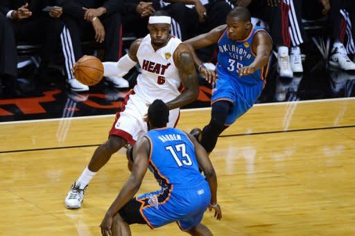 Miami Heat's LeBron James (L) gets past Oklahoma City Thunder's James Harden (front) and Kevin Durant during game three of the NBA Finals on June 17. Miami beat Oklahoma City 91-85 to take the lead in the NBA Finals