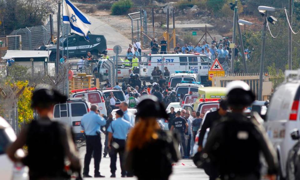 Israeli security personnel and emergency services gather at the site of an attack at the entrance to the West Bank settlement of Har Adar.