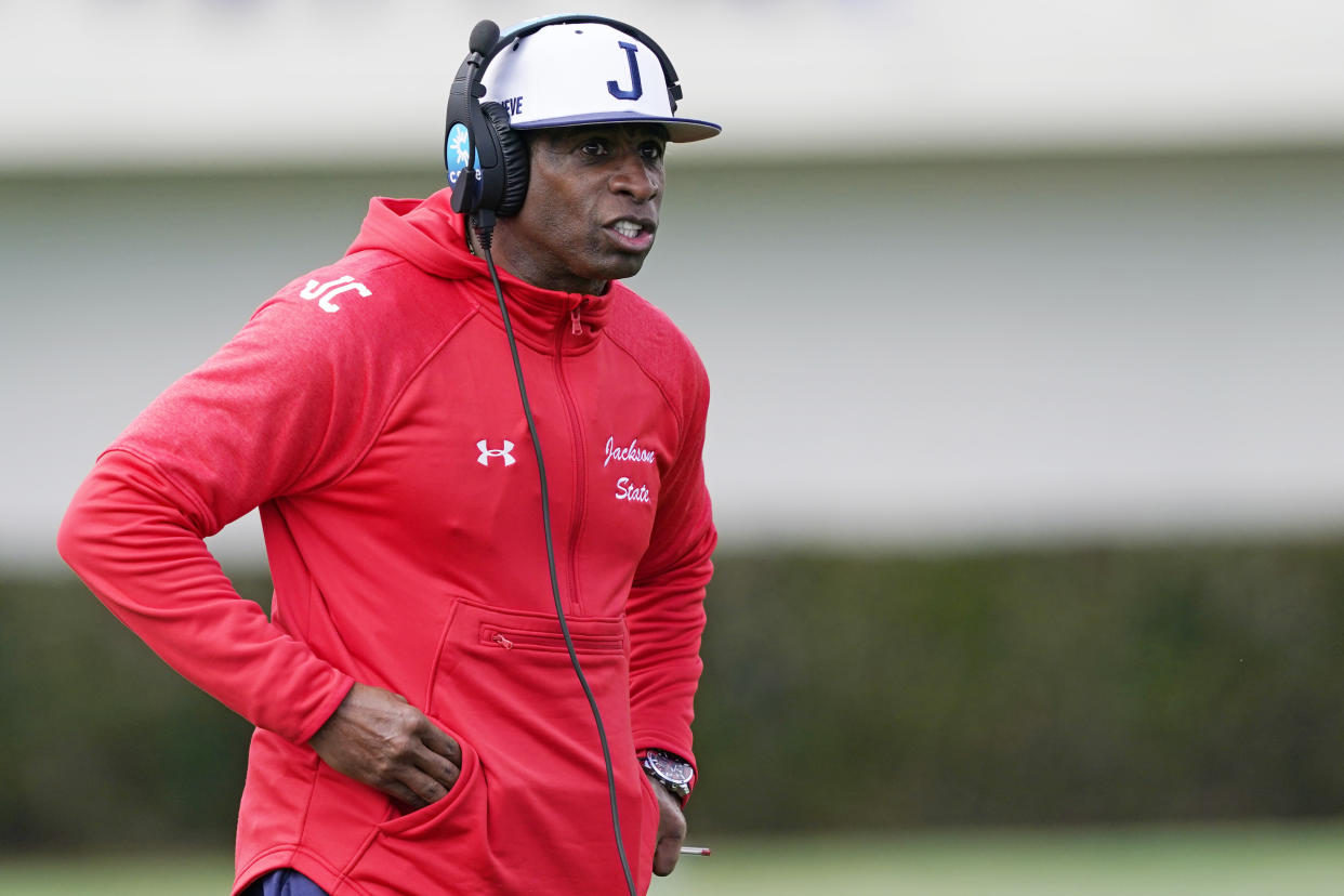 Jackson State football coach Deion Sanders calls out to his players during the first half of an NCAA college football against Edward Waters in Jackson, Miss., Sunday, Feb. 21, 2021. The game marks Sanders's collegiate head coaching debut. (AP Photo/Rogelio V. Solis)