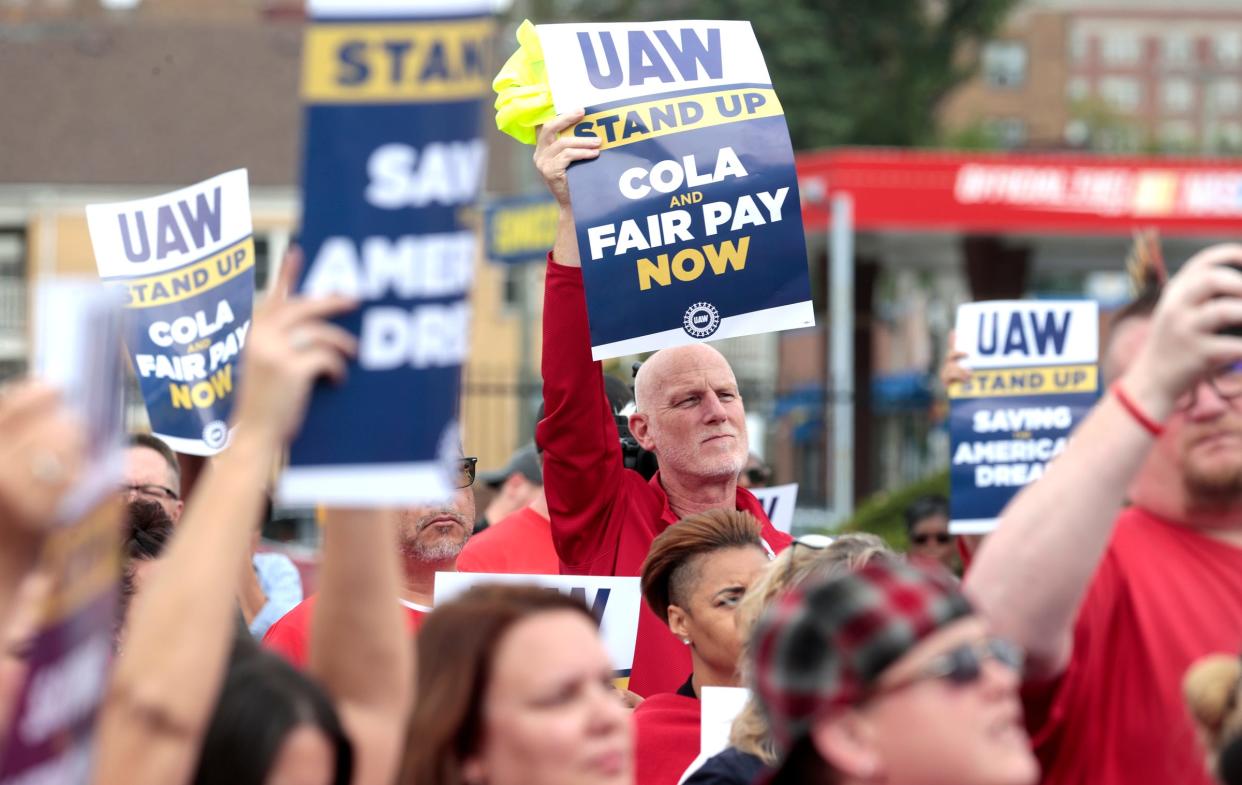 Ken Smith, center, who works in research at the UAW Solidarity House on Jefferson Avenue in Detroit, listens to UAW President Shawn Fain talk to strikers during a rally on Sept. 29, 2023.