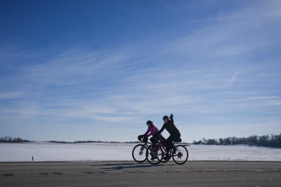 Two bicyclists ride down Highway 144 outside of Perry during the 46th Annual BRR Ride on Saturday, Feb. 4, 2023.