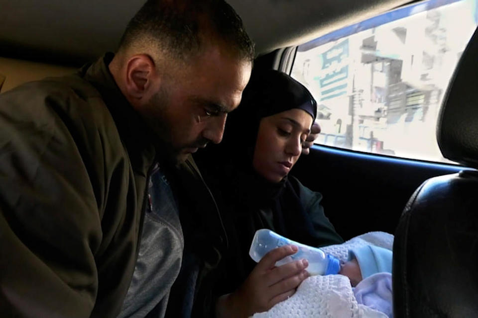 Anas Stateh is fed by his mother in the back of a vehicle.  (NBC News)