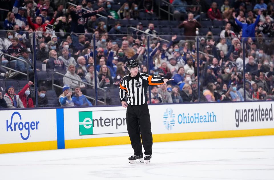 Referee Peter MacDougall rules a good goal for Toronto Maple Leafs center Jason Spezza after review during the third period of the NHL hockey game at Nationwide Arena in Columbus on Feb. 22, 2022. The goal was ruled good and sent the game into overtime. The Blue Jackets won 4-3 in the extra period.