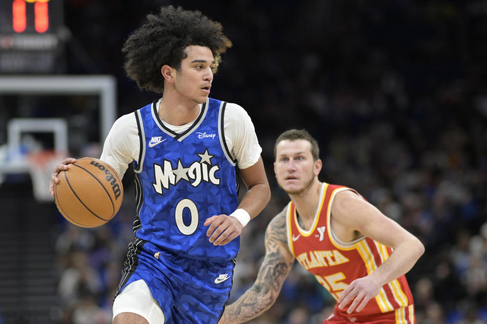 Orlando Magic guard Anthony Black (0) drives past Atlanta Hawks guard Garrison Mathews, right, during the first half of an NBA basketball game, Sunday, Jan. 7, 2024, in Orlando, Fla. (AP Photo/Phelan M. Ebenhack)