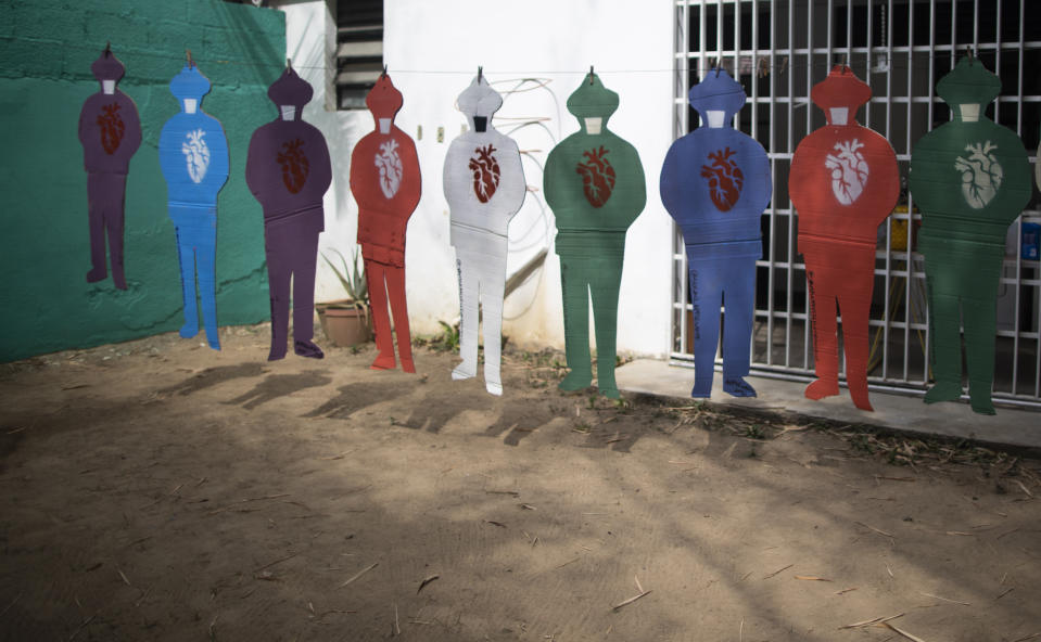 Cardboard silhouettes representing the late Venezuelan Dr. Jose Gregorio Hernandez, known as the "doctor of the poor, constructed by artist Susan Applewhite, hang from a clothesline in her backyard in Caracas, Venezuela, Saturday, April 24, 2021. Hernandez is set to be beatified by the Catholic church, a step towards sainthood, on April 30th in the Venezuelan capital. (AP Photo/Ariana Cubillos)